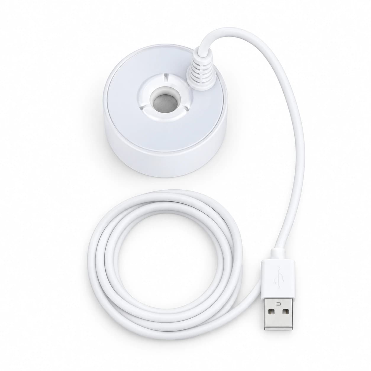 Contenu du colis : le disque brumisateur blanc et son câble USB de 140 cm posés à plat