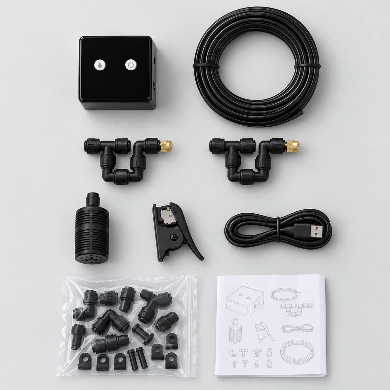 Vue à plat du kit : boîtier, buses, tuyau, crépine, pince, câble et notice