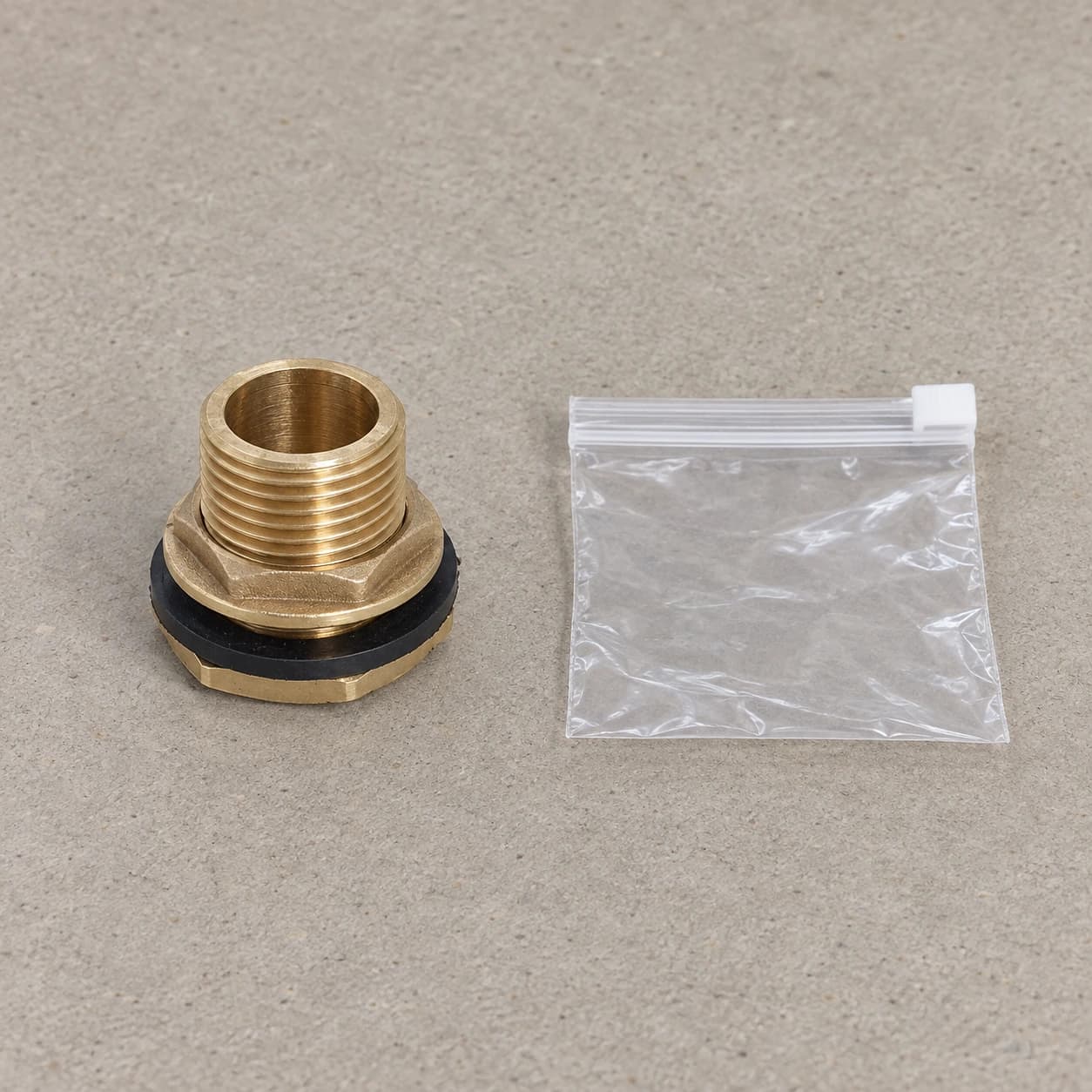 Contenu du colis : une traversée de paroi laiton et son sachet zip transparent