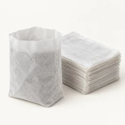 Sachet de semis non tissé ouvert devant la pile du lot de 100