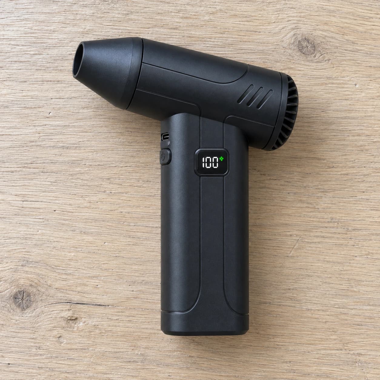 Contenu du colis : le mini souffleur rechargeable seul, posé à plat sur un plan de travail