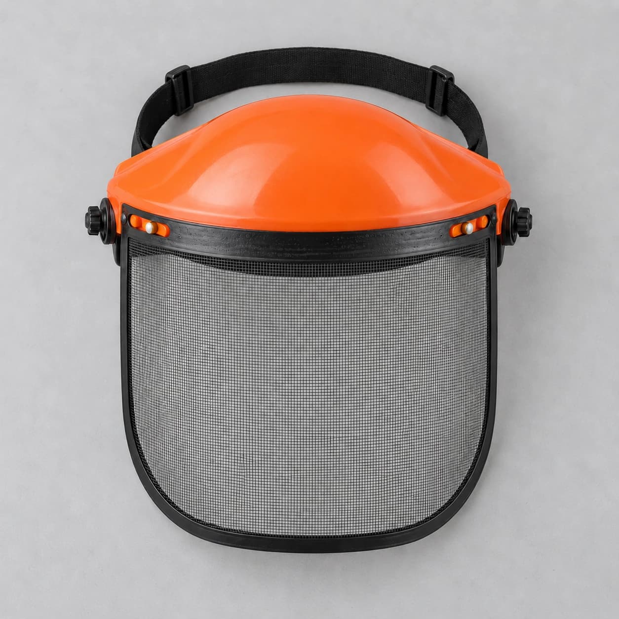 Le bouclier complet assemblé posé à plat : coque orange, serre-tête et visière grillagée, vendu à l'unité
